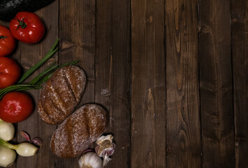 Obraz na płótnie Canvas vegetables and bread on a wooden board