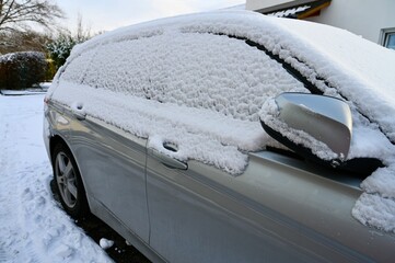 Silber car under snow in the parking. los.