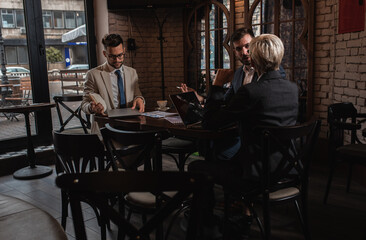 Fototapeta premium Business people holding a meeting at office cafeteria discussing about business plan.