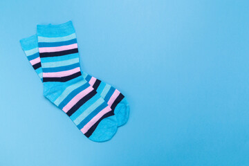 blue new socks stacked on a blue background. top view.