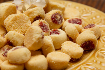 Traditional Brazilian guava paste cookies called goiabinha on wooden table.