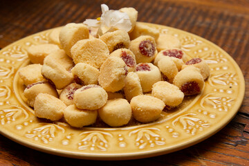 Traditional Brazilian guava paste cookies called goiabinha on wooden table.