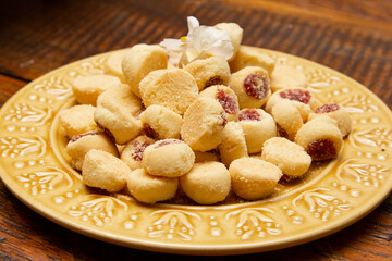 Traditional Brazilian guava paste cookies called goiabinha on wooden table.