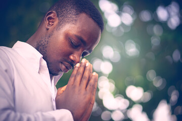 African man praying for thank god.Low key style