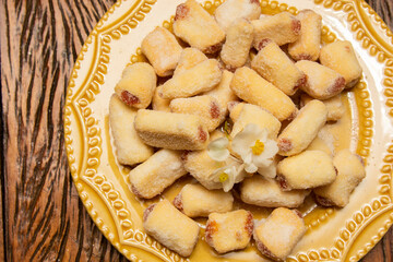 Traditional Brazilian guava paste cookies called goiabinha on wooden table.