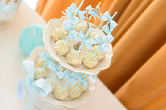 White chocolate cake pops with sprinkles on a sweet table at the family party