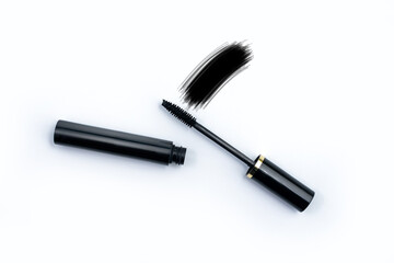 Black mascara applicator brush with sample smudge white isolated background