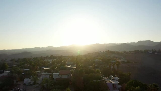 Small village in the desert at sunset, aerial view
drone view Palm trees Mountains and red rofftops,vered yericho, Israel
