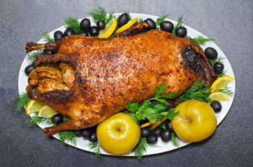 Christmas roast duck with apples, lemon, olives and herbs. The view from the top