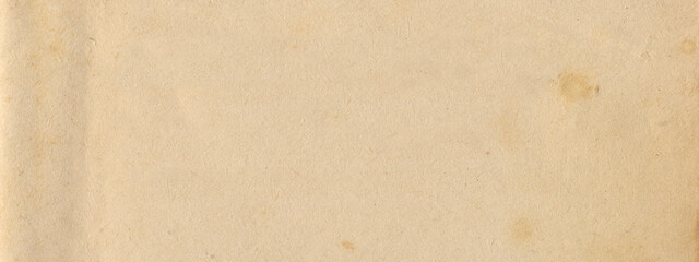 Old paper vintage brown or beige retro design background with damaged, weathered dirty surface. A rustic grungy textured material like a blank horizontal parchment page, an empty manuscript texture