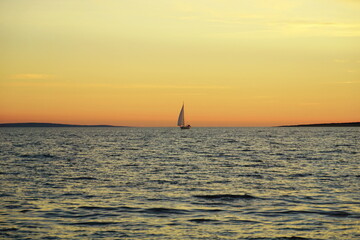 Fototapeta na wymiar Vintage scene of yacht on the ocean at sunset
