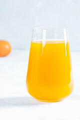 Multifruit juice in glass on white background. Orange juice.Fresh fruits.Healthy food and drink. Lemons and tangerines.  