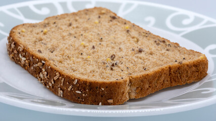 A slice of brown bread in a plate with shallow depth of field
