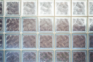Closeup shot of square glass windows with light in the background