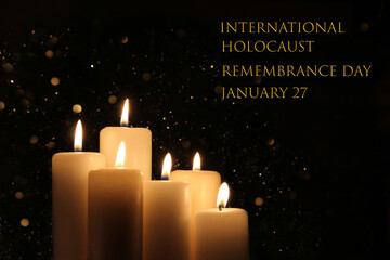International Holocaust Remembrance Day January 27. Burning six white candles with lights glow on...