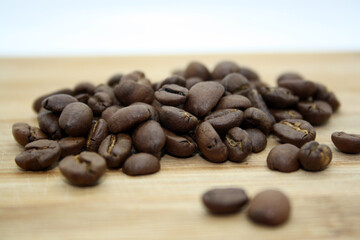 Coffe beans on a wooden background.