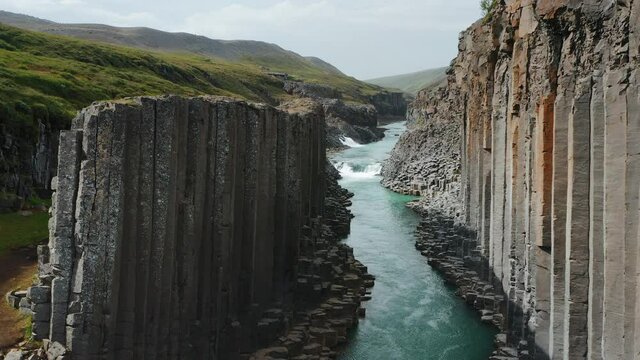 Aerial footage of Studlagil volcanic basalt Canyon, Jokulsa Bru river Highlands of Iceland Popular tourist attraction.