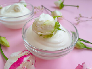 cosmetic cream, rose flower on a colored background