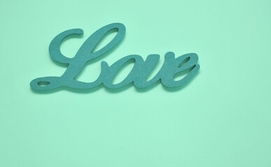 Wooden letter Love on blue background