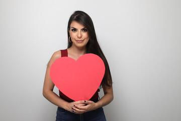 Fototapeta na wymiar beautiful girl holding valentine's gift on white background