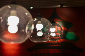 Retro light bulb in the dark cafe interior. Selective focus