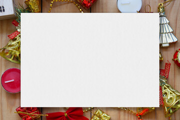 Empty white paper on Christmas and new year decorations on wooden floor.