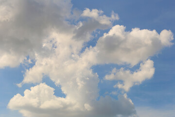 Blue sky with white clouds in the daytime background.