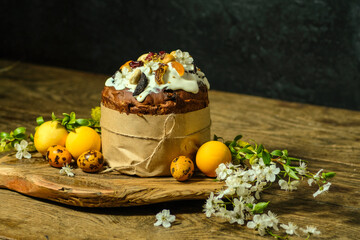Easter cake, eggs and cherry branches on a black background. Still life on a wooden background. low key shooting