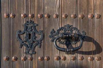 Detail of an antique door handle made of iron