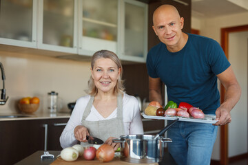 A vegetarian family cooks lunch in their kitchen.