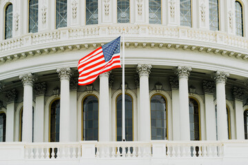 American flag on the background of the Capitol