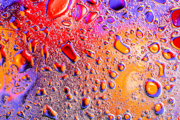 Colorful abstract background. Water drops rainbow colors on glass. Amazing abstract water drops on glass texture or background.
