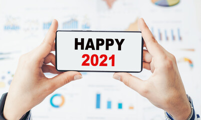 Closeup on businessman holding a smartphone with text HAPPY 2021.