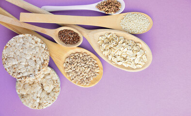 different types of diet bread, round buckwheat crispbread, wheat crispbread and crispbread with oatmeal flakes and wheat grains, flax and sesame seeds, healthy flour - body measuring tape background