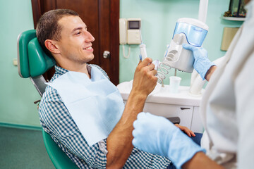 Importance of dental irrigator in effective oral care. Cleansing the cavity between the teeth....