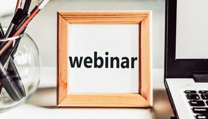 WEBINAR text in wooden frame on office table.