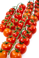 cherry tomatoes on branch on white background