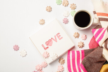 Gift box, a cup of coffee and a scarf on a light background with sweets. Composition Valentine's Day. Banner. Flat lay, top view