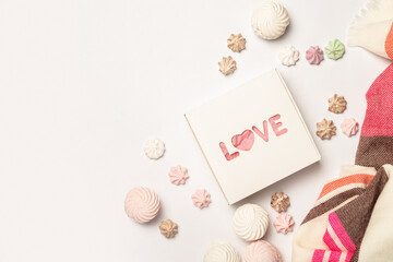 Gift box, beautiful scarf, meringues and sweets on a light background. Composition Valentine's Day. Banner. Flat lay, top view
