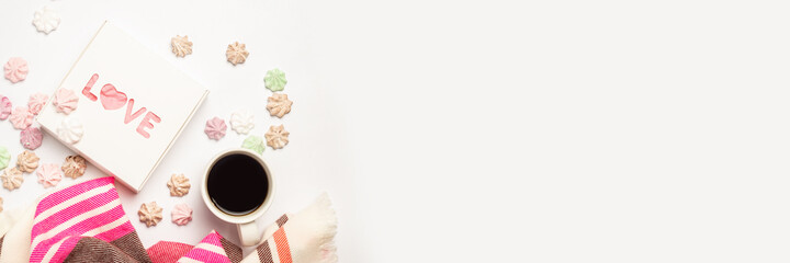 Gift box, a cup of coffee and a scarf on a light background with sweets. Composition Valentine's Day. Banner. Flat lay, top view