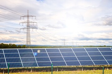 Solar panels with electricity pylons at sunset ,  power plant