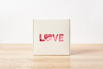 Gift box with the text Love. Valentine's Day gift concept. Narrow focus. Banner