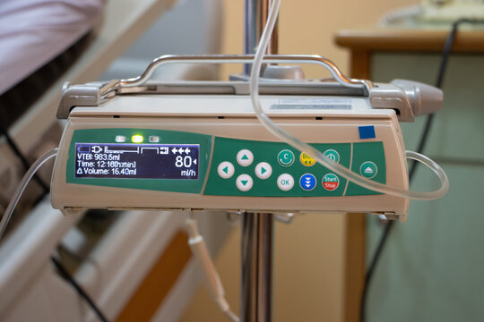 The automatic infusion device working beside the bed at hospital.
