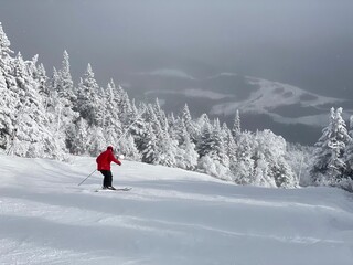 Fototapeta na wymiar View to ski slopes with lot of fresh powder snow at Stowe Mountain resort VT in early December