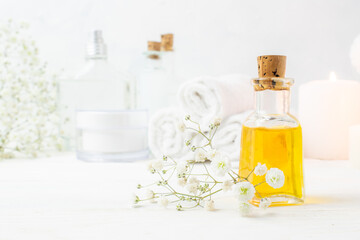 Obraz na płótnie Canvas A jar of essential oil on a wooden table. Spa treatments. Massage. Cosmetics.
