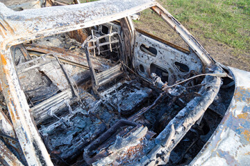 Burned down car, abstract background, selective focus. The situation of protests in the world.