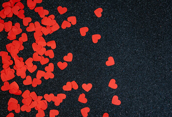 many red hearts on black glitter background, valentine's day