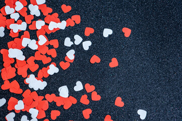 many red and white hearts on black glitter background, valentine's day