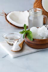 An arrangement of coconut oil, coconut MTC oil and coconut water against a light background.
