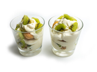 tiramisu in a transparent glass with kiwi on a white background